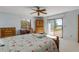 Bright bedroom features a large window and sliding glass doors to the patio at 1905 S Riverside Dr, Edgewater, FL 32141