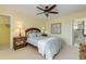 Bright bedroom features a ceiling fan, closet, and an ensuite bathroom at 1905 S Riverside Dr, Edgewater, FL 32141