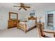 Cozy bedroom features a ceiling fan and a doorway that leads to the bathroom at 1905 S Riverside Dr, Edgewater, FL 32141