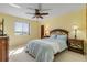 Bright bedroom features a ceiling fan, large window, and natural lighting at 1905 S Riverside Dr, Edgewater, FL 32141
