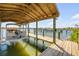 This covered boat dock features a lift and wood construction, providing a great waterfront space for a boat at 1905 S Riverside Dr, Edgewater, FL 32141