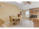 Cozy dining area with a brick fireplace and natural light at 1905 S Riverside Dr, Edgewater, FL 32141
