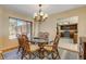 Bright dining room showcases a glass table, six chairs, and a kitchen view at 1905 S Riverside Dr, Edgewater, FL 32141