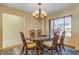 Cozy dining room with a glass-top table, six chairs, and a stylish chandelier at 1905 S Riverside Dr, Edgewater, FL 32141