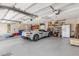Spacious garage with a gray Corvette, storage shelves, and room for kayaks and other recreational equipment at 1905 S Riverside Dr, Edgewater, FL 32141