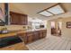 Modern kitchen featuring wood cabinetry, ample countertop space, and views to living areas at 1905 S Riverside Dr, Edgewater, FL 32141