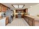 Spacious kitchen featuring wood cabinets, a breakfast bar, and stainless steel appliances at 1905 S Riverside Dr, Edgewater, FL 32141
