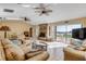 Cozy living room featuring a brick fireplace and waterfront views at 1905 S Riverside Dr, Edgewater, FL 32141