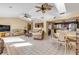 Bright living room featuring tile floors, ceiling fans, skylights, and comfortable seating at 1905 S Riverside Dr, Edgewater, FL 32141