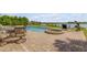 Paver patio with a pool, spa, and lovely seating area, with waterfront views on a bright day at 1905 S Riverside Dr, Edgewater, FL 32141