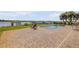 Large paver patio featuring a swimming pool, lounge chairs and waterfront views, perfect for relaxing and enjoying outdoors at 1905 S Riverside Dr, Edgewater, FL 32141