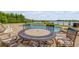 A paver patio featuring a pool, spa, and outdoor table with chairs offering a picturesque waterfront view at 1905 S Riverside Dr, Edgewater, FL 32141
