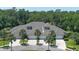 Aerial view of a property with lush landscaping, and attached garages at 1999 Turnbull Lakes Dr, New Smyrna Beach, FL 32168