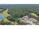 Aerial view of a house surrounded by lush greenery, a pond, and a golf course at 1999 Turnbull Lakes Dr, New Smyrna Beach, FL 32168