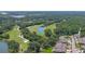 Panoramic aerial view showcases the community, golf course, and surrounding natural beauty at 1999 Turnbull Lakes Dr, New Smyrna Beach, FL 32168