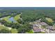 Scenic aerial shot of golf community residences nestled amongst mature trees, ponds, and a sprawling golf course at 1999 Turnbull Lakes Dr, New Smyrna Beach, FL 32168