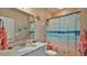 Beach-themed bathroom featuring starfish decor, a shower curtain, and granite vanity at 1999 Turnbull Lakes Dr, New Smyrna Beach, FL 32168