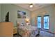 Airy bedroom with soft natural light, beach themed decor, and sliding glass door access at 1999 Turnbull Lakes Dr, New Smyrna Beach, FL 32168