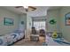 Shared bedroom featuring twin beds, desks, and bright sea-themed decor and a window at 1999 Turnbull Lakes Dr, New Smyrna Beach, FL 32168