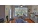 Bright dining area with large windows, tile floors, and casual decor at 1999 Turnbull Lakes Dr, New Smyrna Beach, FL 32168