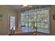 Inviting dining area with natural light, garden views, and beach decor at 1999 Turnbull Lakes Dr, New Smyrna Beach, FL 32168
