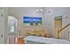 Bright dining room with hardwood floors, modern chandelier, and coastal-themed art at 1999 Turnbull Lakes Dr, New Smyrna Beach, FL 32168
