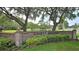 Charming entrance sign for Turnbull Estates framed by mature trees and landscaped greenery at 1999 Turnbull Lakes Dr, New Smyrna Beach, FL 32168