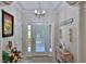 Bright entryway features a front door, coat rack, and beach-themed decor at 1999 Turnbull Lakes Dr, New Smyrna Beach, FL 32168