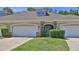 Charming townhome featuring a well-maintained front yard and attached two-car garage at 1999 Turnbull Lakes Dr, New Smyrna Beach, FL 32168