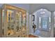 Elegant foyer showcasing wood floors, chandelier, and glass display cabinet at 1999 Turnbull Lakes Dr, New Smyrna Beach, FL 32168