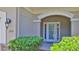 Inviting front entrance with decorative shrubs, stone accents and a stylish front door at 1999 Turnbull Lakes Dr, New Smyrna Beach, FL 32168