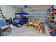 Organized garage space with a golf cart, dining set, and storage shelves, ready for hobbies and projects at 1999 Turnbull Lakes Dr, New Smyrna Beach, FL 32168