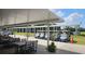 Neat row of golf carts parked under a shaded structure with outdoor seating area at 1999 Turnbull Lakes Dr, New Smyrna Beach, FL 32168