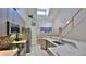 Contemporary kitchen with breakfast bar, stainless appliances, and view to dining area at 1999 Turnbull Lakes Dr, New Smyrna Beach, FL 32168