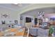 Open-concept living room flows into the kitchen; featuring modern lighting and decor at 1999 Turnbull Lakes Dr, New Smyrna Beach, FL 32168