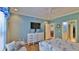Airy bedroom features beach-themed decor with views to the en-suite bathroom and kitchen at 1999 Turnbull Lakes Dr, New Smyrna Beach, FL 32168