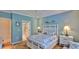 Bright bedroom with beach-themed decor, matching nightstands, and an ensuite bathroom at 1999 Turnbull Lakes Dr, New Smyrna Beach, FL 32168