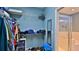 Walk-in closet with shelving and rod, with a small mirror and access to bathroom with glass shower door at 1999 Turnbull Lakes Dr, New Smyrna Beach, FL 32168