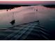 An aerial view of a scenic community waterway with boats sailing on a tranquil evening at 1999 Turnbull Lakes Dr, New Smyrna Beach, FL 32168