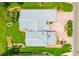 An aerial view shows a home with a brick driveway, lush landscaping and a concrete-tile roof at 2005 Country Club Dr, Port Orange, FL 32128
