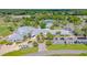 An expansive aerial view highlights the community's clubhouse, pool, tennis courts, golf carts, and convenient parking facilities at 2005 Country Club Dr, Port Orange, FL 32128