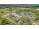 Sweeping aerial showcases the community with golf course, lake, tennis courts, pool, clubhouse, parking, and lush landscaping at 2005 Country Club Dr, Port Orange, FL 32128