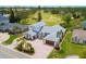 Aerial view showcasing the home's circular driveway, manicured landscaping, and proximity to the golf course at 2005 Country Club Dr, Port Orange, FL 32128
