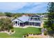 Aerial view of home with manicured lawn, pristine landscaping, and inviting outdoor spaces at 2005 Country Club Dr, Port Orange, FL 32128