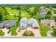 Stunning aerial view of a home on a golf course with a pool and circular driveway at 2005 Country Club Dr, Port Orange, FL 32128