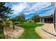Beautifully landscaped backyard with manicured lawn and stone pathway at 2005 Country Club Dr, Port Orange, FL 32128