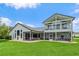 Beautifully landscaped backyard with lush lawn and outdoor seating areas for relaxing or entertaining at 2005 Country Club Dr, Port Orange, FL 32128
