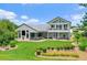 Expansive backyard showcasing lush landscaping, outdoor seating, and a stunning two-story home at 2005 Country Club Dr, Port Orange, FL 32128