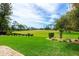 Lush backyard with manicured lawn and landscaping overlooking the green golf course at 2005 Country Club Dr, Port Orange, FL 32128