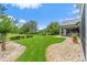 Expansive backyard with lush green lawn, mature trees, and meticulously maintained landscaping at 2005 Country Club Dr, Port Orange, FL 32128